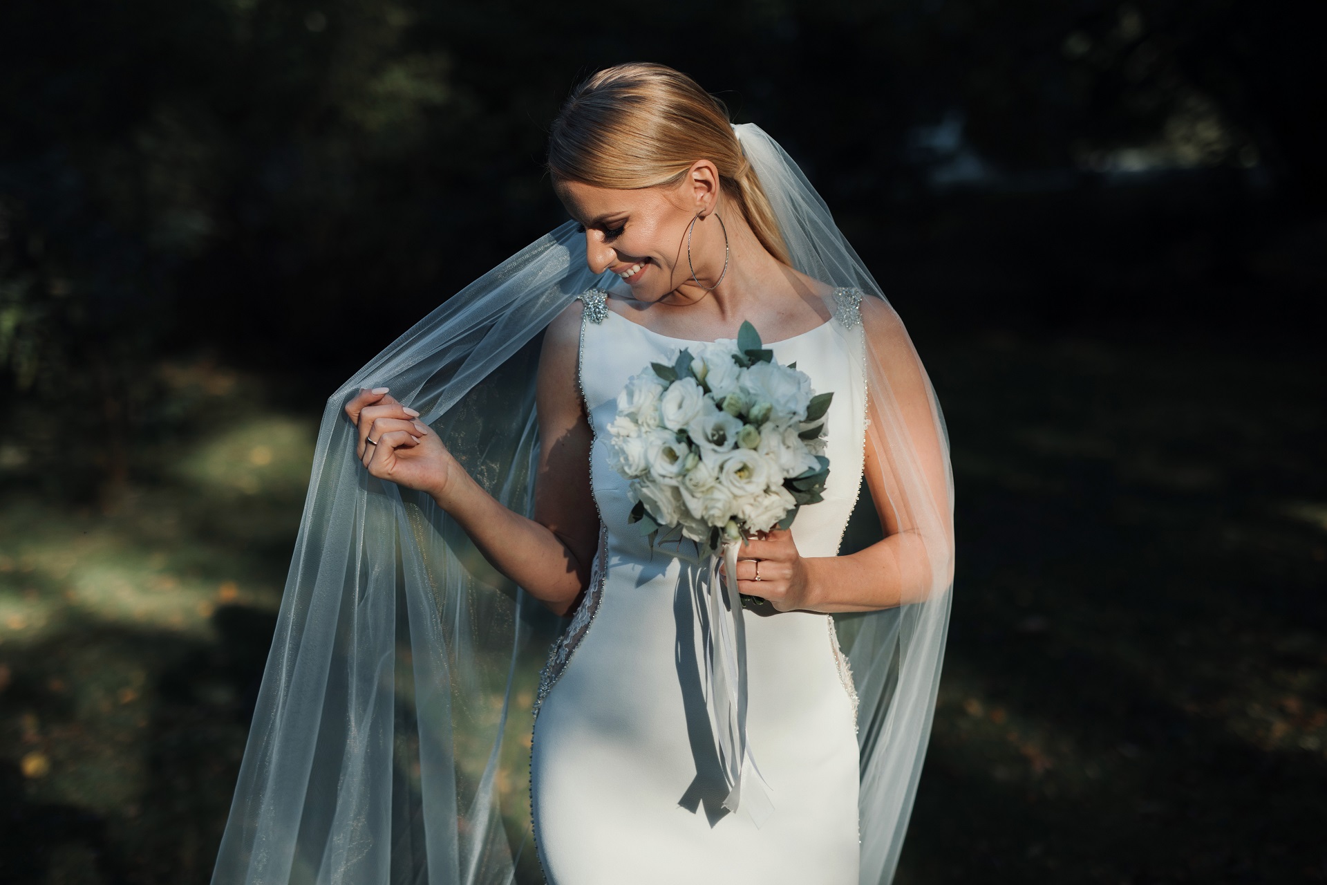 Panna Młoda w gładkiej sukni ślubnej z eleganckim bukietem